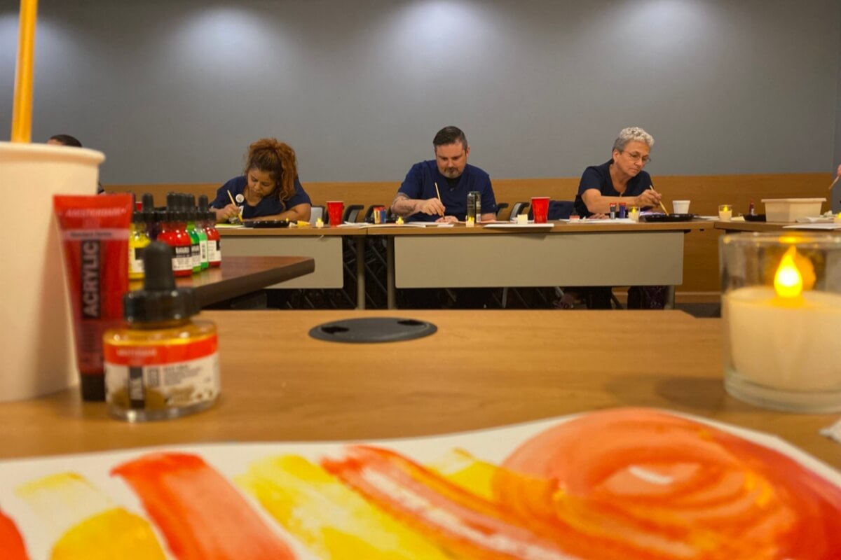 People painting in a professional learning program.