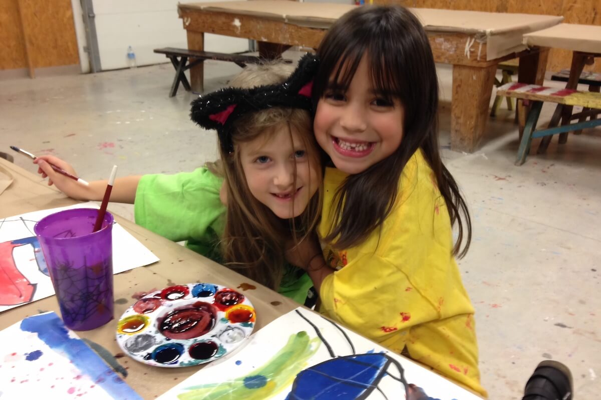 Two kids painting during an Arts Lab class.